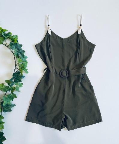 Black slip dress styled with botanical accessories